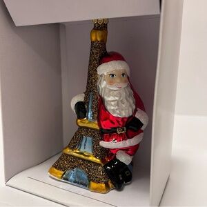 Celtic Glass Christmas Ornament Featuring Santa Leaning in the Eiffel Tower